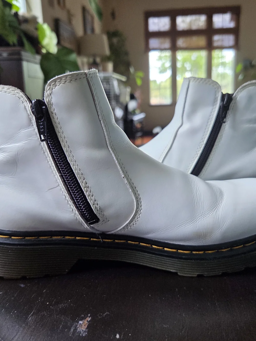 These are Dr. Martens Youth 2976 Chelsea Boots, featuring white leather